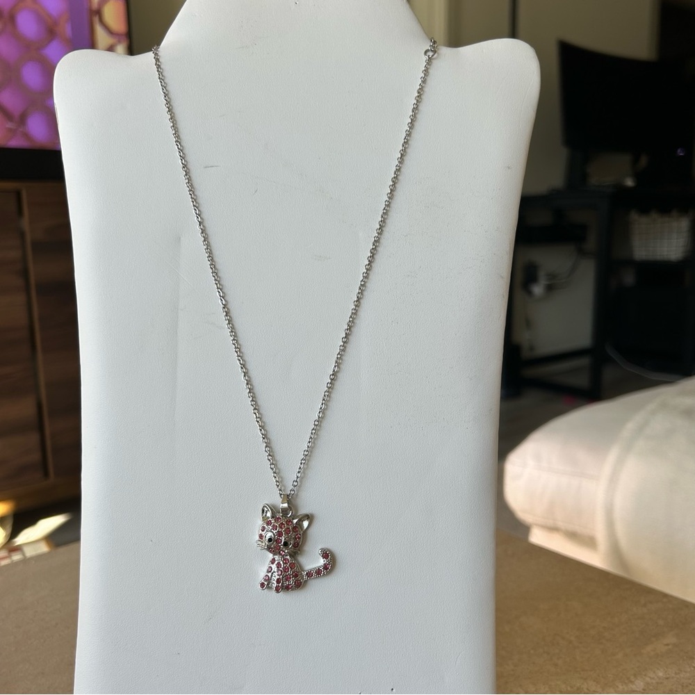silver-tone cat pendant necklace featuring pink rhinestones